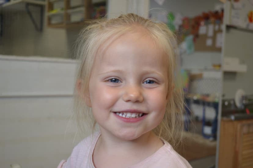 Caring staff nurturing young children in a warm environment